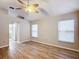 Bedroom with vaulted ceiling, wood-look floors and ceiling fan at 2117 Sansores St, The Villages, FL 32159