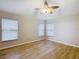 Spacious bedroom with wood-look floors and ceiling fan at 2117 Sansores St, The Villages, FL 32159