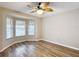 Bright bedroom with wood-look floors and ceiling fan at 2117 Sansores St, The Villages, FL 32159