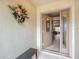 Front entry with decorative wreath and bench at 2117 Sansores St, The Villages, FL 32159