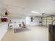 Garage with workshop area, utility sink, and storage at 2117 Sansores St, The Villages, FL 32159