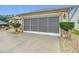 Screened-in garage with neutral color palette at 2117 Sansores St, The Villages, FL 32159