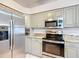 Modern kitchen featuring stainless steel appliances and granite countertops at 2117 Sansores St, The Villages, FL 32159