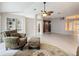 Open living room with built-in shelving and a view into the kitchen area at 2117 Sansores St, The Villages, FL 32159