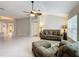 Spacious living room with tiled floors and views into other rooms of the home at 2117 Sansores St, The Villages, FL 32159