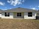 The back of this house reveals a large backyard with three windows looking out into the yard at 2134 Nw 23Rd Loop, Ocala, FL 34475