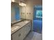 Bathroom featuring double sinks, granite countertops and access into the primary bedroom at 2134 Nw 23Rd Loop, Ocala, FL 34475