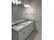 Bathroom with double vanity, granite countertop, modern fixtures, and white cabinets at 2134 Nw 23Rd Loop, Ocala, FL 34475
