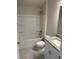 Bright bathroom with a shower-tub combo, granite countertop sink and tile flooring at 2134 Nw 23Rd Loop, Ocala, FL 34475