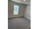 Bedroom with carpet, a window and neutral paint, creating a serene atmosphere at 2134 Nw 23Rd Loop, Ocala, FL 34475