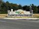 Attractive West Oak Village community entrance sign with stacked stone and lush landscaping at 2134 Nw 23Rd Loop, Ocala, FL 34475