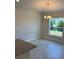 Bright dining area with tile flooring, a chandelier, and a large window with a view at 2134 Nw 23Rd Loop, Ocala, FL 34475