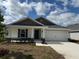 Charming single-story home with a two-car garage, landscaped yard, and stone accents on the facade at 2134 Nw 23Rd Loop, Ocala, FL 34475