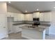 Well-lit kitchen featuring white cabinetry, granite countertops, stainless steel appliances, and a kitchen island at 2134 Nw 23Rd Loop, Ocala, FL 34475