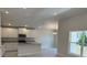 Bright kitchen featuring white cabinets, stainless steel appliances, and a granite countertop island at 2134 Nw 23Rd Loop, Ocala, FL 34475