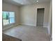 Open-concept living area features ample natural light, neutral walls, and tile flooring at 2134 Nw 23Rd Loop, Ocala, FL 34475