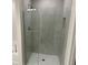 Modern glass-enclosed shower with gray tile and built-in niche in the primary bathroom at 2134 Nw 23Rd Loop, Ocala, FL 34475