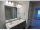 Modern bathroom with double sinks, granite countertops, and a large mirror at 2138 Nw 23Rd Loop, Ocala, FL 34475