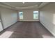 This bedroom features neutral walls, carpet and two windows with views of the green outdoors at 2138 Nw 23Rd Loop, Ocala, FL 34475