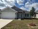 Charming single-story home with a well-manicured front yard and a two-car garage at 2138 Nw 23Rd Loop, Ocala, FL 34475