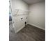 This laundry room features tile floors, washer/dryer hookups, and a wire shelf for storage at 2138 Nw 23Rd Loop, Ocala, FL 34475