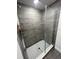 This shower features tile walls, white tile floor and glass door at 2138 Nw 23Rd Loop, Ocala, FL 34475