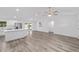 Open-concept living room featuring light gray floors, white walls, and a kitchen with stainless steel appliances at 5222 Nw 54Th Pl, Ocala, FL 34482