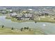 Aerial view of community with lake, clubhouse, and golf course at 8729 Sw 61St Loop, Ocala, FL 34481