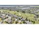 Aerial view of homes, golf course, and lake at 8729 Sw 61St Loop, Ocala, FL 34481