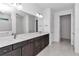 Double vanity bathroom with dark brown cabinets and a large mirror at 8729 Sw 61St Loop, Ocala, FL 34481