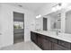 Modern bathroom with double vanity, dark cabinetry, and large mirror at 8729 Sw 61St Loop, Ocala, FL 34481