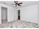 Spacious bedroom with ceiling fan and neutral carpeting at 8729 Sw 61St Loop, Ocala, FL 34481