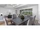 Elegant dining room features a dark wood table and gray chairs, overlooking a patio at 8729 Sw 61St Loop, Ocala, FL 34481