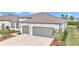Two-car garage and front landscaping of single-Gathering home at 8729 Sw 61St Loop, Ocala, FL 34481