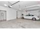 Two-car garage with white car and overhead storage at 8729 Sw 61St Loop, Ocala, FL 34481