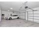Two-car garage with white car and overhead storage at 8729 Sw 61St Loop, Ocala, FL 34481