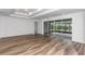 Spacious Gathering room with wood-look flooring and access to a covered patio at 8729 Sw 61St Loop, Ocala, FL 34481