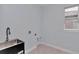 Laundry room with utility sink and window at 8729 Sw 61St Loop, Ocala, FL 34481