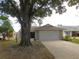 Home with mature tree and driveway at 9101 Sw 91St Cir, Ocala, FL 34481