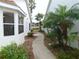 Peaceful walkway leading to a house with palm trees at 9101 Sw 91St Cir, Ocala, FL 34481