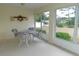 Bright sunroom with table and chairs, overlooking the garden at 9101 Sw 91St Cir, Ocala, FL 34481