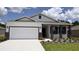 Charming single-story home featuring a two-car garage and professionally landscaped front yard at 9287 Sw 60Th Court Rd, Ocala, FL 34476