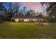 Ranch-style home with large backyard at dusk at 10249 Nw 21St St, Ocala, FL 34482