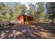 Wooden barn with red siding and covered porch at 10249 Nw 21St St, Ocala, FL 34482