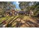 Charming brick home with a covered front porch surrounded by lush greenery at 10249 Nw 21St St, Ocala, FL 34482