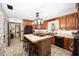 Kitchen with brick accent wall, island, and wood cabinets at 10249 Nw 21St St, Ocala, FL 34482