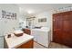 Clean laundry room with modern washer, dryer, and countertop space at 10249 Nw 21St St, Ocala, FL 34482