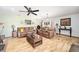 Spacious living room featuring wood floors and comfortable leather sofas at 10249 Nw 21St St, Ocala, FL 34482