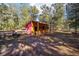 Outdoor building with wood siding and a covered porch nestled in a wooded area at 10249 Nw 21St St, Ocala, FL 34482