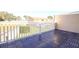 The balcony includes tile flooring, and a white railing overlooking the landscaped yard at 11001 Se Sunset Harbor Rd # F45, Summerfield, FL 34491